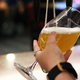 Bartender's hands holding pint of beer as tap pours